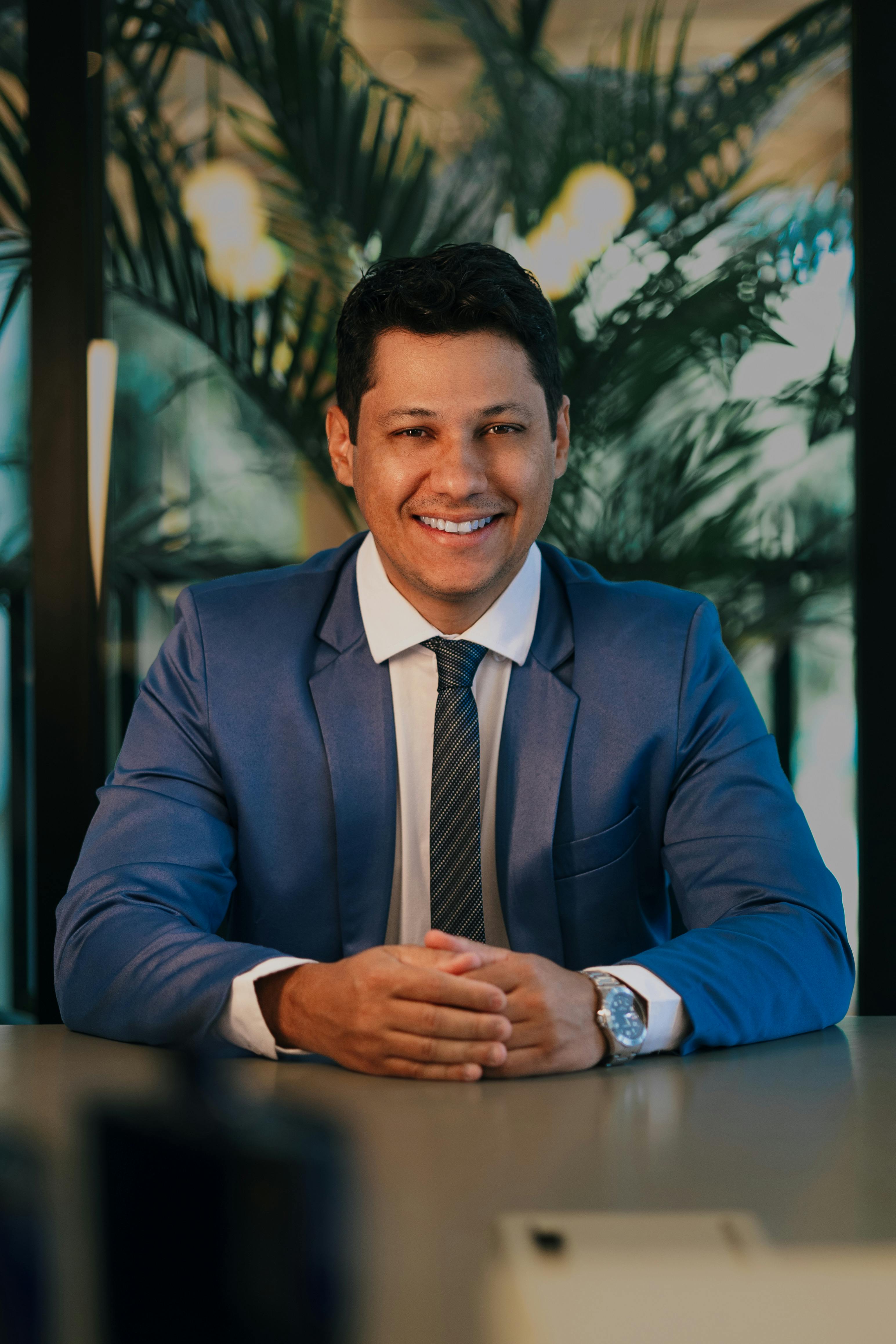 Young handsome caucasian smart man outdoors sitting bench using computer smiling